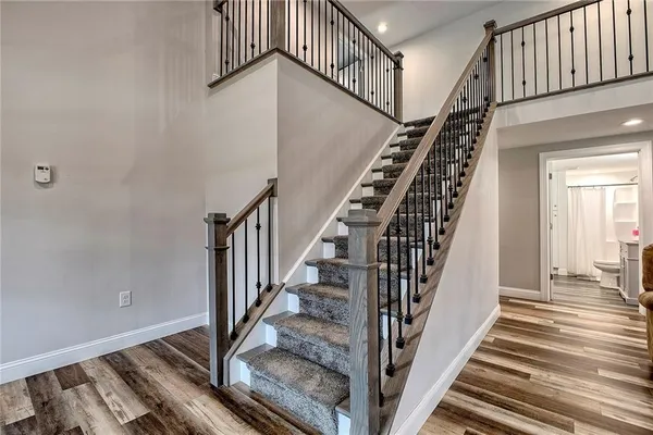a view of a hallway with wooden floor and entryway
