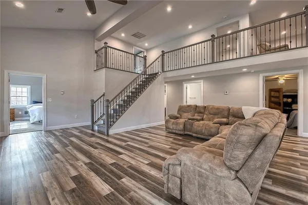 a living room with furniture or stairs and a wooden floor