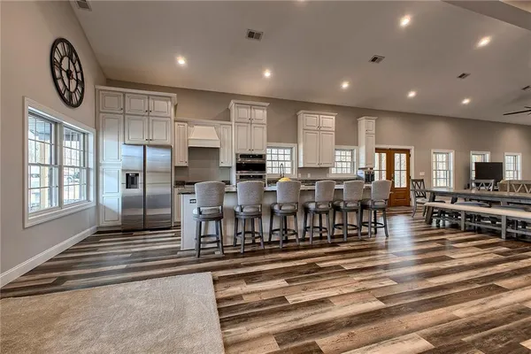 a very nice looking open dining room with kitchen island furniture and a chandelier