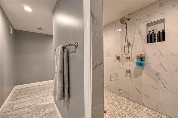 a bathroom with a shower and a mirror