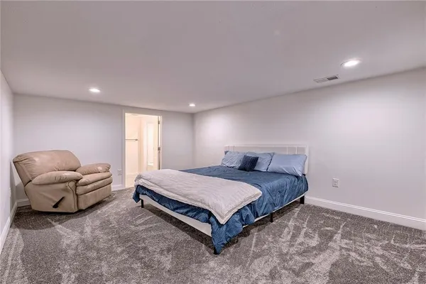 a spacious bedroom with a bed and a couch