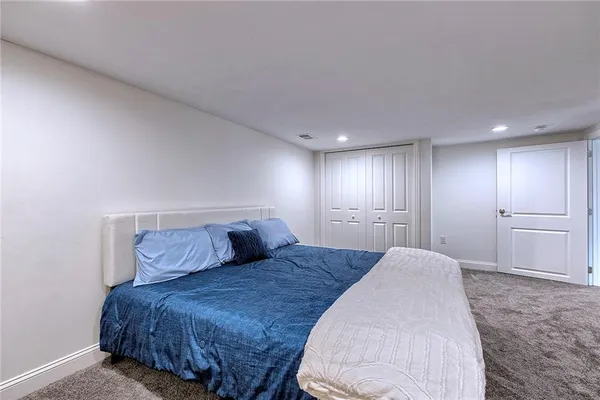 a spacious bedroom with a bed and a view of bathroom