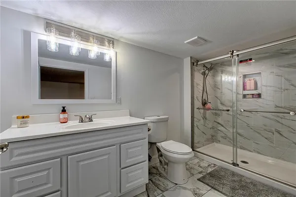 a bathroom with a toilet sink and shower