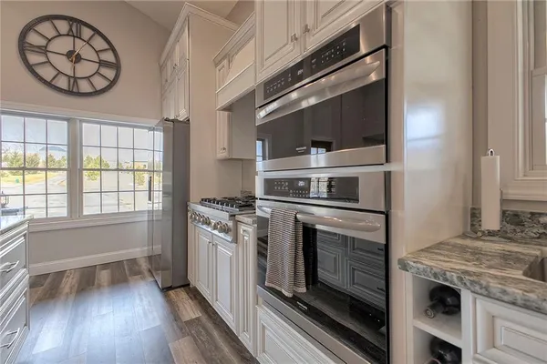 a kitchen with stainless steel appliances granite countertop a stove and a microwave