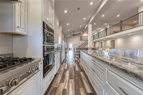 a kitchen with granite countertop lots of counter top space and stainless steel appliances