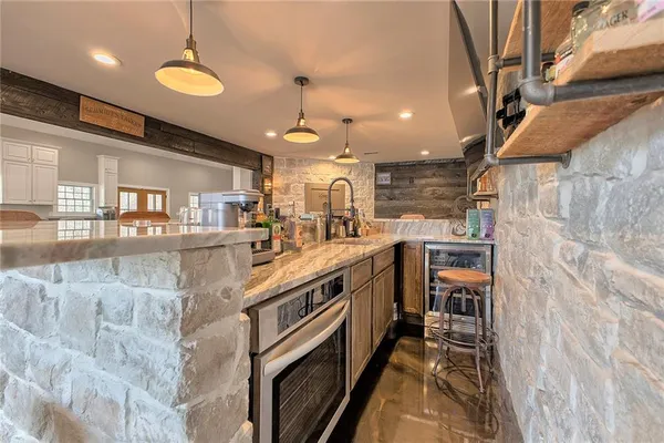 a kitchen with stainless steel appliances granite countertop a sink and cabinets