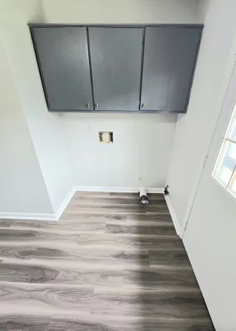 a view of a closet with wooden floor