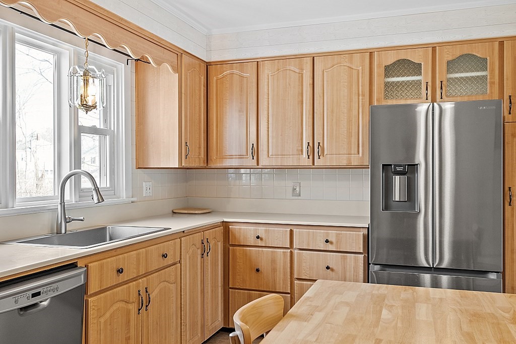 19 South Hampton Road Amesbury, MA 01913 - Photo 17 of 42 a kitchen with a sink a refrigerator and cabinets