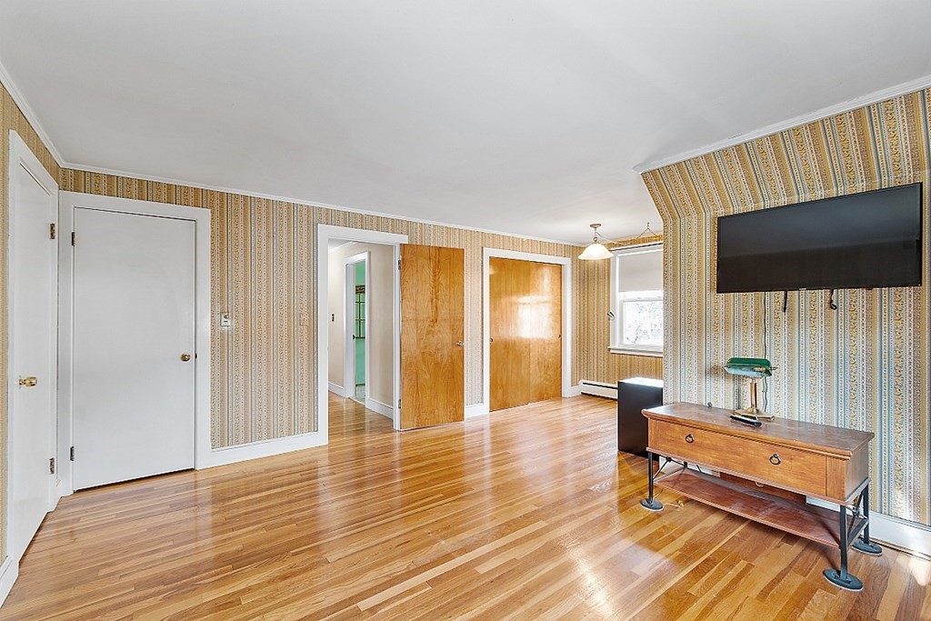 19 South Hampton Road Amesbury, MA 01913 - Photo 34 of 42 a living room with furniture and a flat screen tv