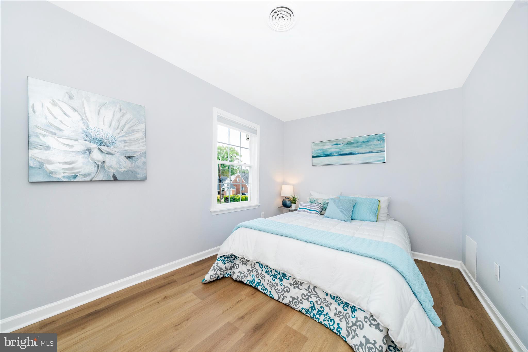 713 Seek Lane Silver Spring, MD 20912 - Photo 28 of 60 a bedroom with a bed and a painting on the wall