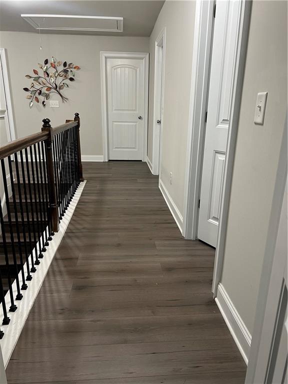 914 Rainsong Court Braselton, GA 30517 - Photo 14 of 37 a view of a hallway view with wooden floor and staircase