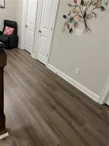 a view of a room with wooden floor