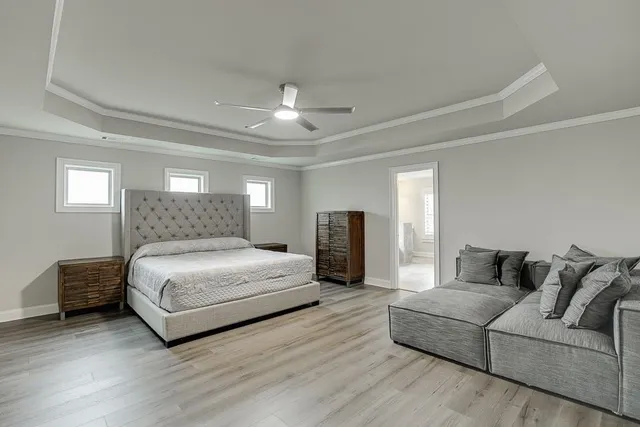 a bedroom with a large bed and a couch