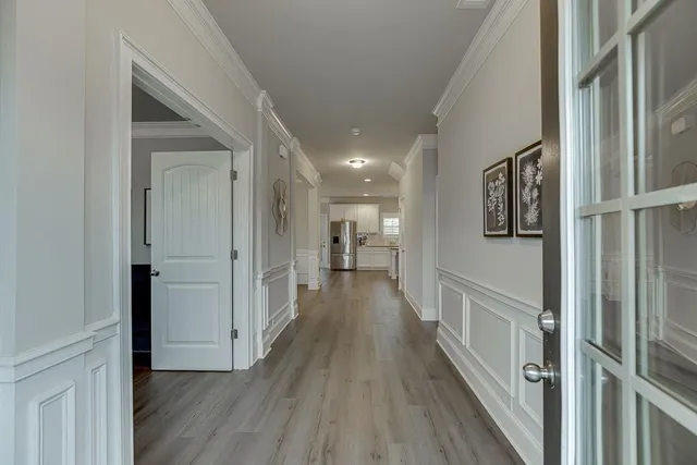 a view of hallway with wooden floor