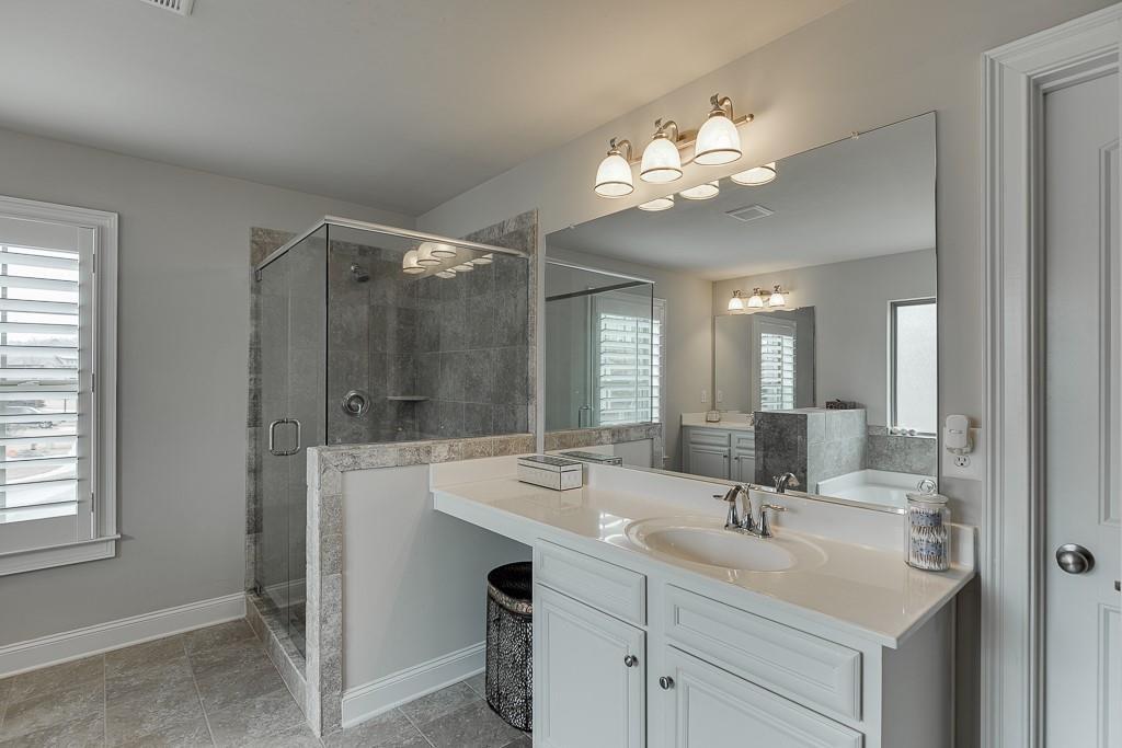 914 Rainsong Court Braselton, GA 30517 - Photo 21 of 37 a bathroom with a sink double vanity and a mirror