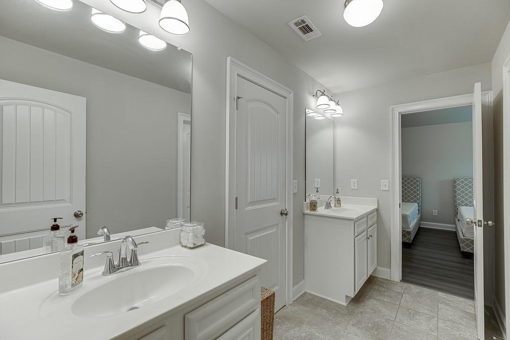914 Rainsong Court Braselton, GA 30517 - Photo 23 of 37 a bathroom with a double vanity sink mirror and toilet