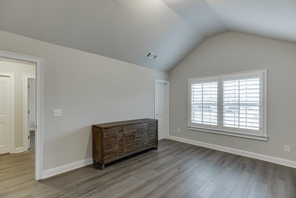 914 Rainsong Court Braselton, GA 30517 - Photo 26 of 37 a view of an empty room with wooden floor and a window