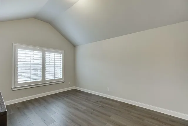 a large bed sitting in a bedroom next to a window