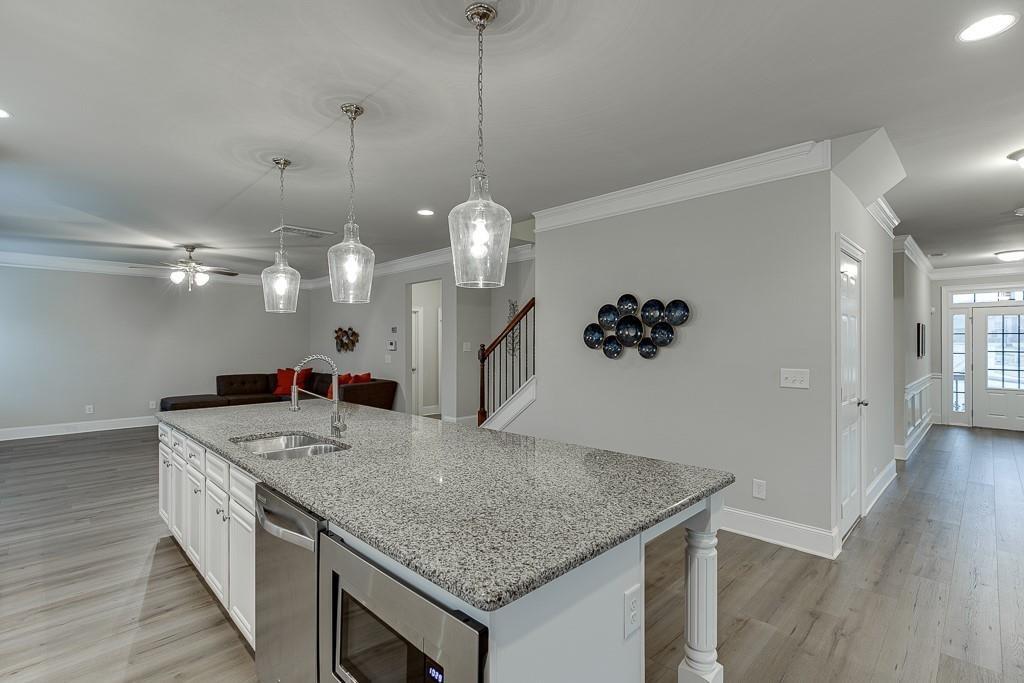 914 Rainsong Court Braselton, GA 30517 - Photo 7 of 37 a kitchen with a counter space cabinetry and wooden floor