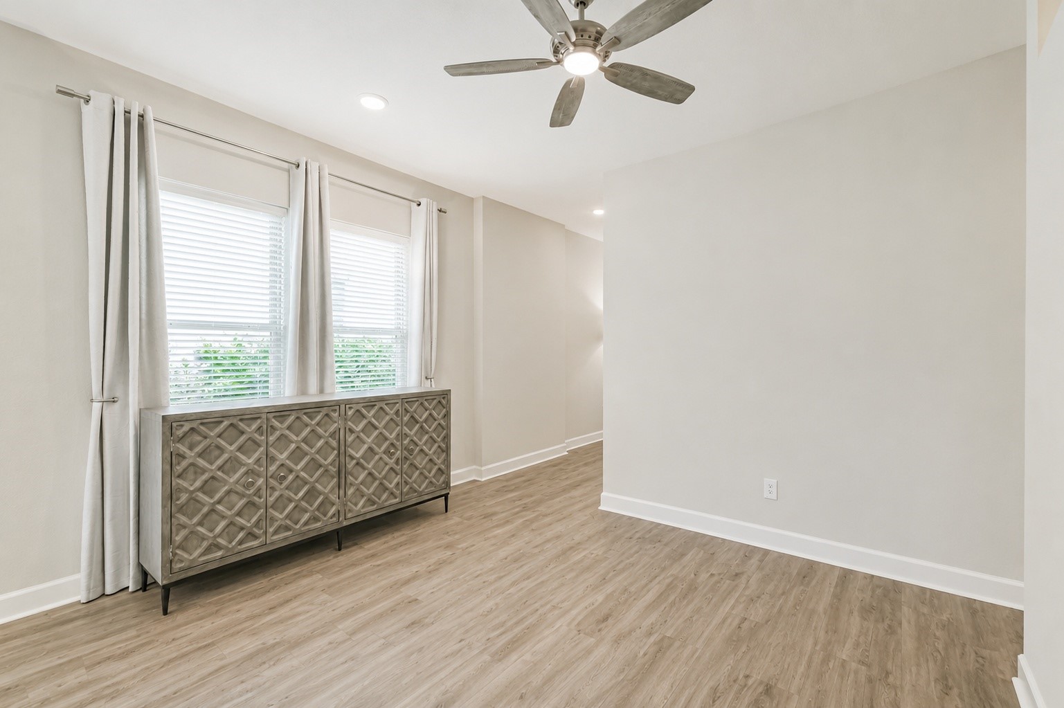 15611 Rising Wren Court Conroe, TX 77302 - Photo 5 of 38 an empty room with wooden floor fan and windows