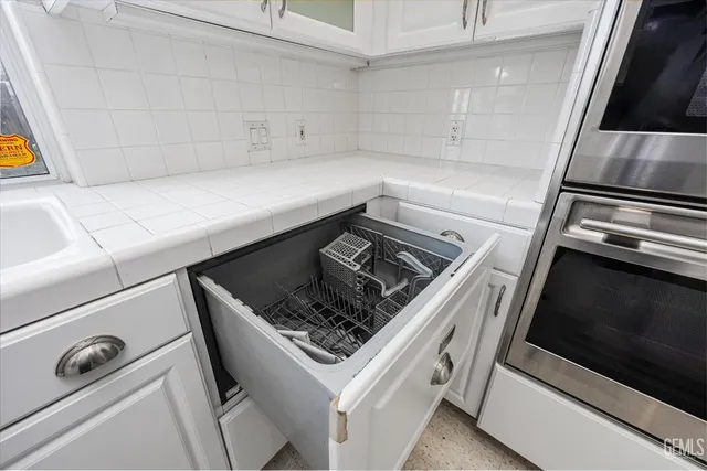 a view of a livingroom with a ceiling fan & window