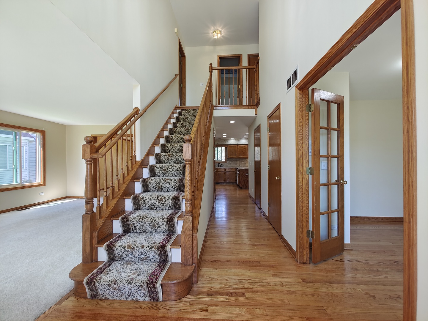 4807 Snapjack Circle Naperville, IL 60564 - Photo 2 of 29 a view of entryway with wooden floor and stairs