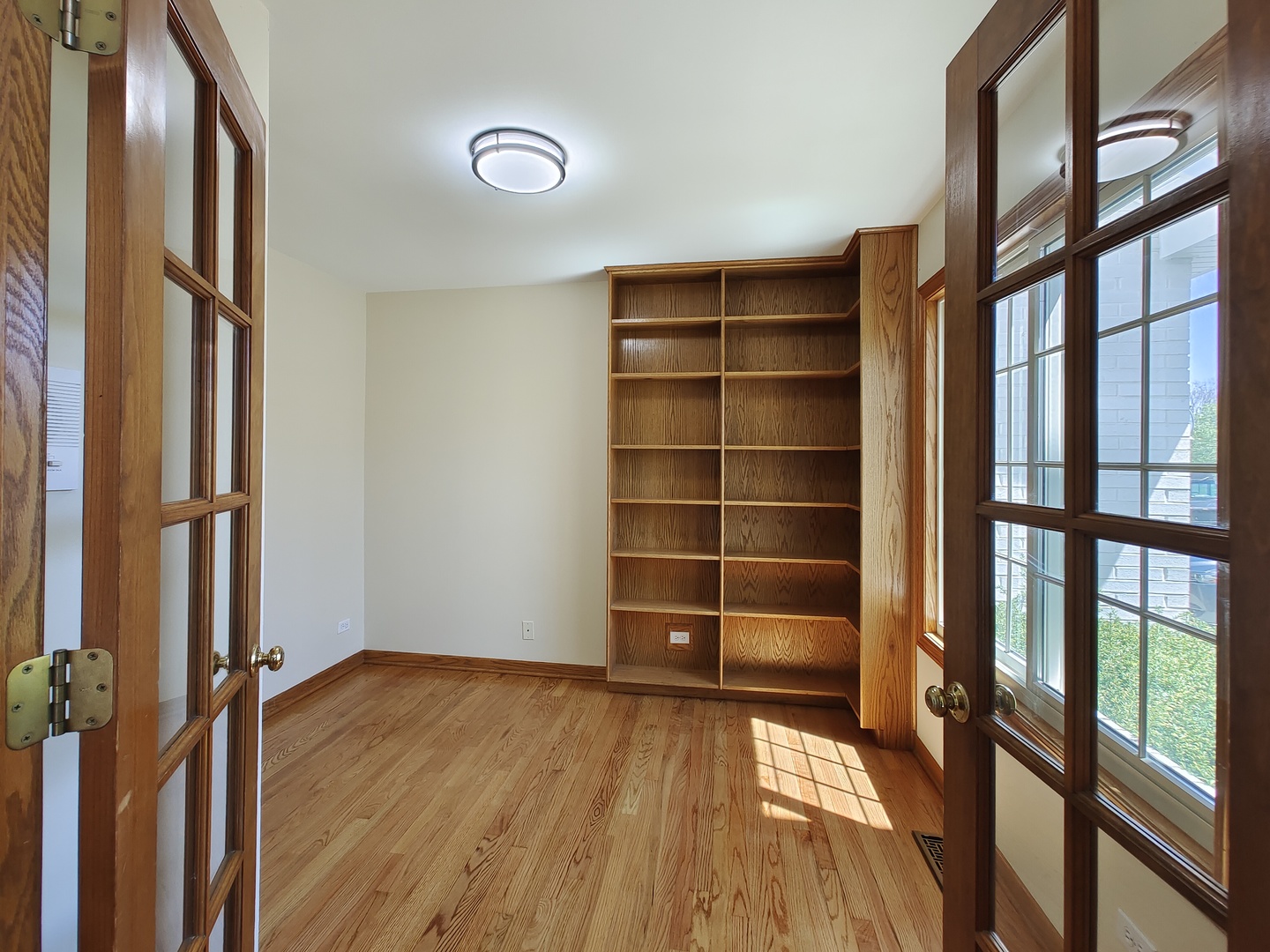4807 Snapjack Circle Naperville, IL 60564 - Photo 5 of 29 a view of an empty room with a window and wooden floor