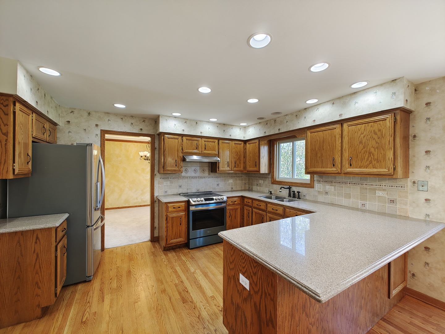 4807 Snapjack Circle Naperville, IL 60564 - Photo 6 of 29 a kitchen with stainless steel appliances granite countertop a sink stove and refrigerator