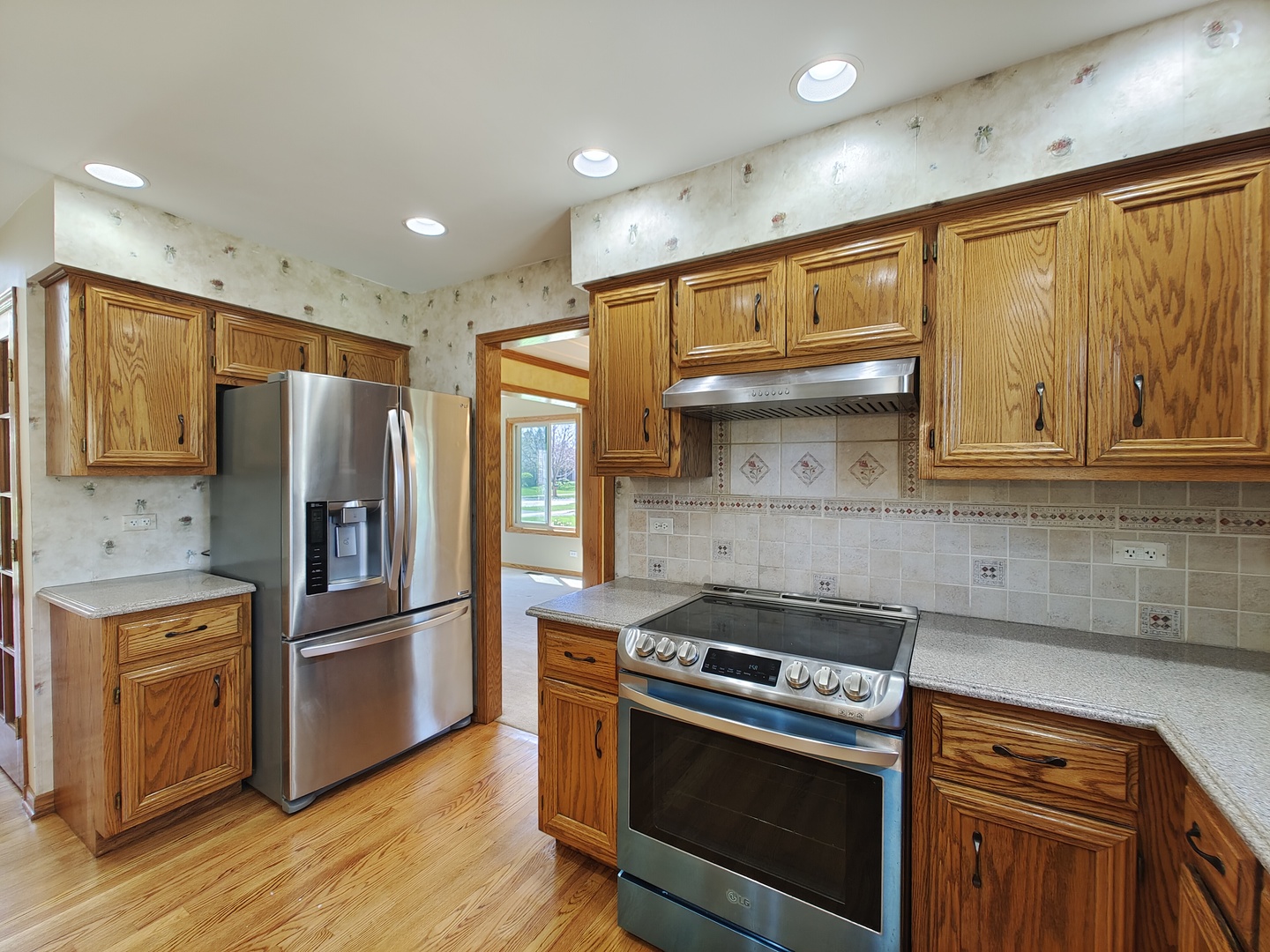 4807 Snapjack Circle Naperville, IL 60564 - Photo 7 of 29 a kitchen with stainless steel appliances granite countertop a stove a refrigerator and a microwave