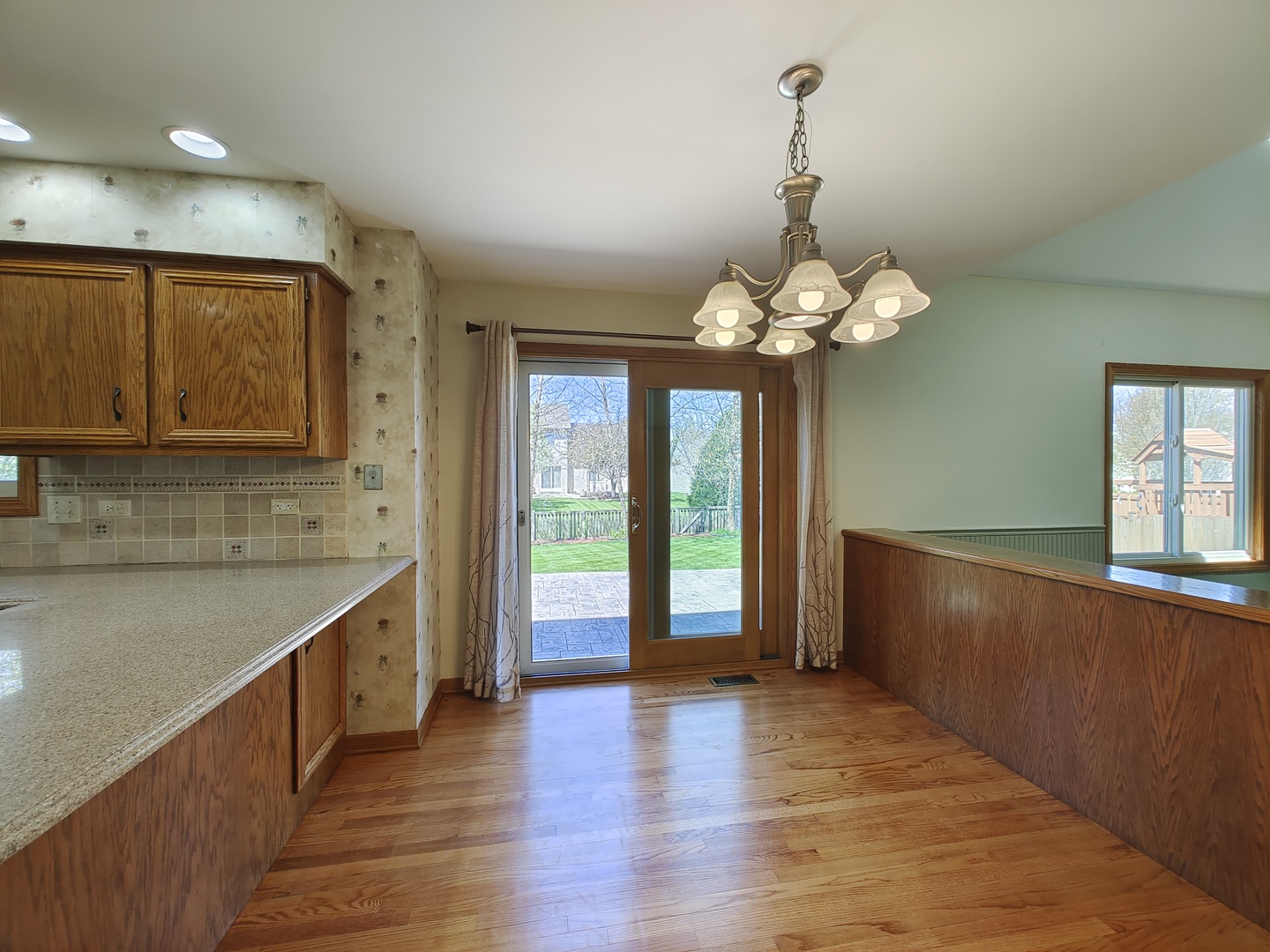 4807 Snapjack Circle Naperville, IL 60564 - Photo 8 of 29 a large kitchen with stainless steel appliances granite countertop a refrigerator a sink dishwasher a oven and a dining table with wooden floor