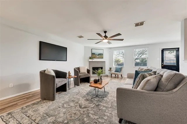 a living room with fireplace furniture and a flat screen tv