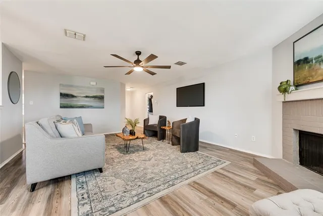 a living room with furniture a flat screen tv and a fireplace