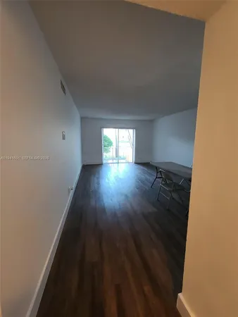a view of wooden floor and windows in a room