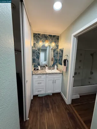 a bathroom with a mirror and a sink