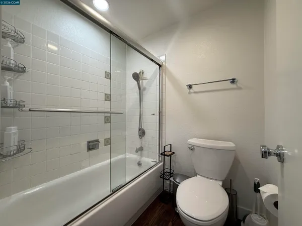 a white toilet and tub sitting next to a bathroom sink