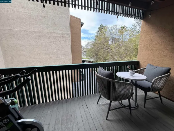 a balcony view with a seating space