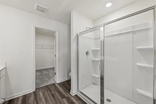 a bathroom with a glass shower door