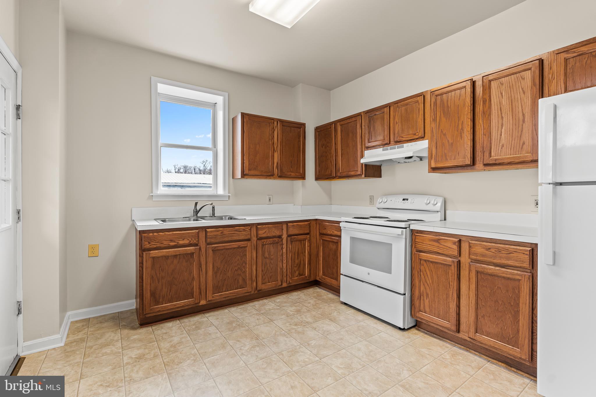 44 Madison Avenue Hagerstown, MD 21740 - Photo 13 of 24 a kitchen with granite countertop a sink stainless steel appliances and cabinets