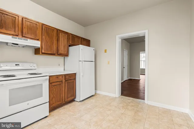 a kitchen with cabinets appliances and a sink