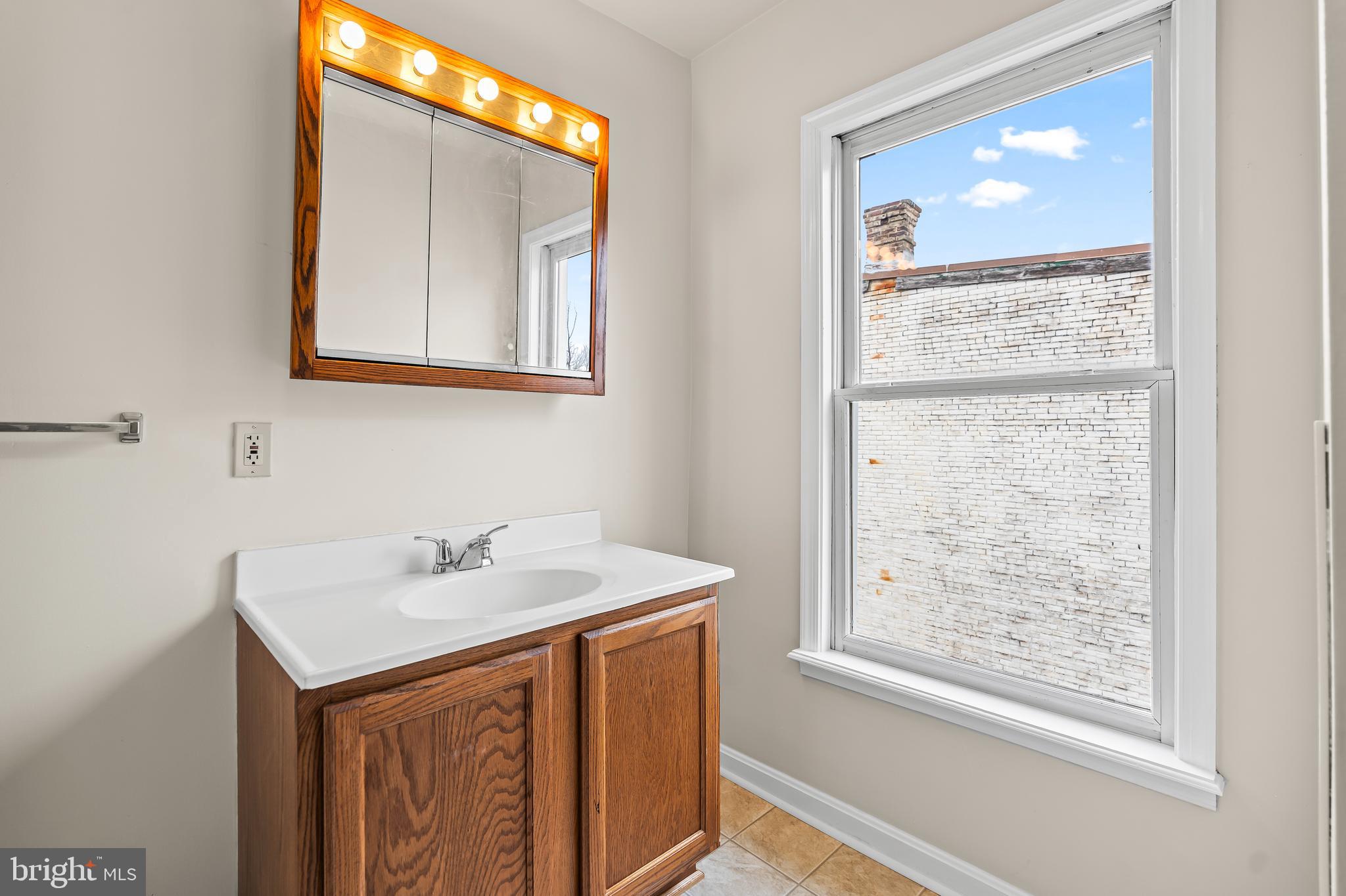 44 Madison Avenue Hagerstown, MD 21740 - Photo 20 of 24 a bathroom with a sink vanity and a mirror