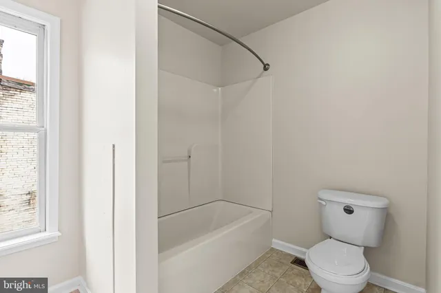 a bathroom with a toilet and a bathtub