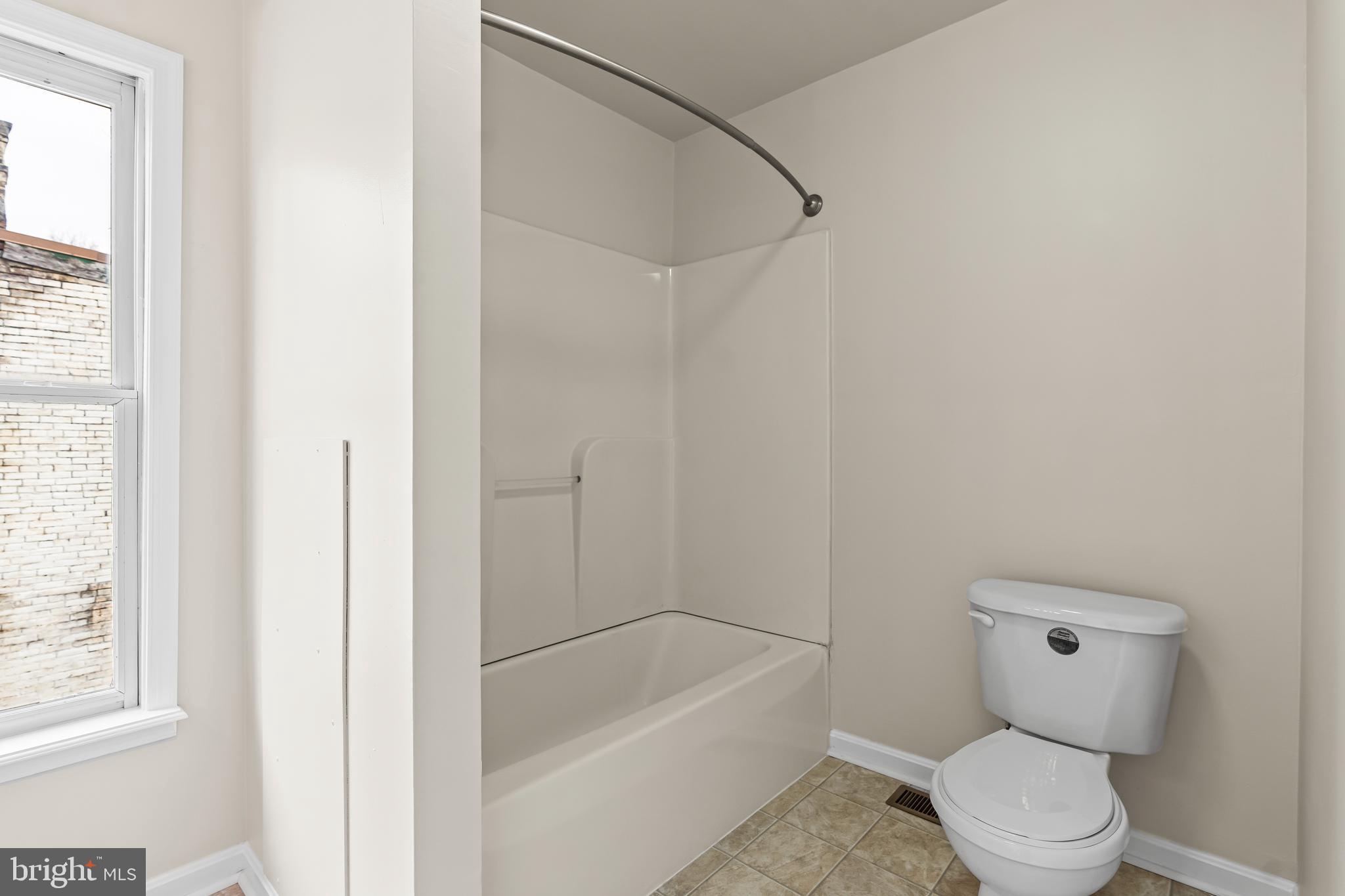 44 Madison Avenue Hagerstown, MD 21740 - Photo 21 of 24 a bathroom with a toilet and a bathtub