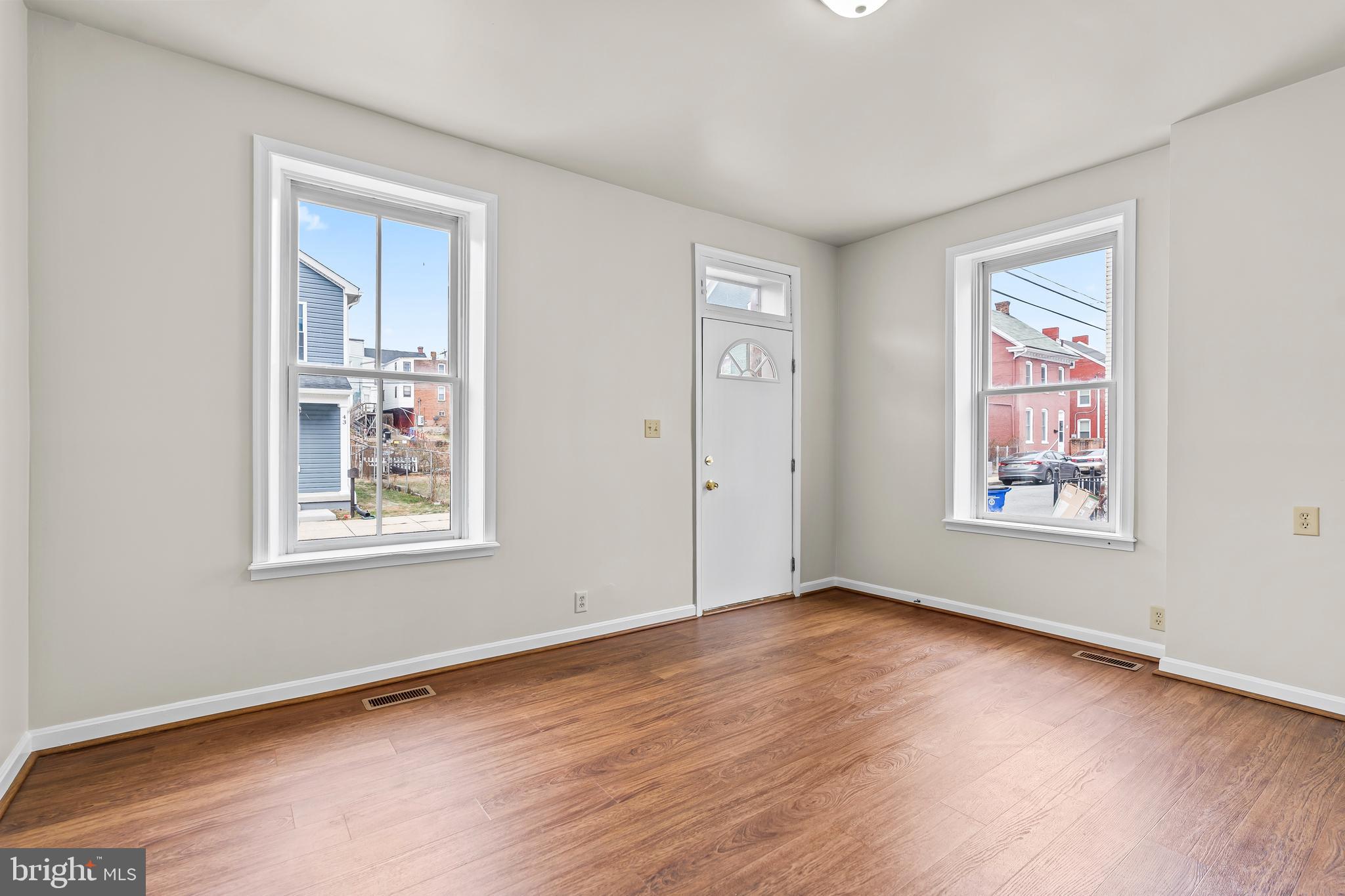 44 Madison Avenue Hagerstown, MD 21740 - Photo 6 of 24 a view of an empty room with wooden floor and a window
