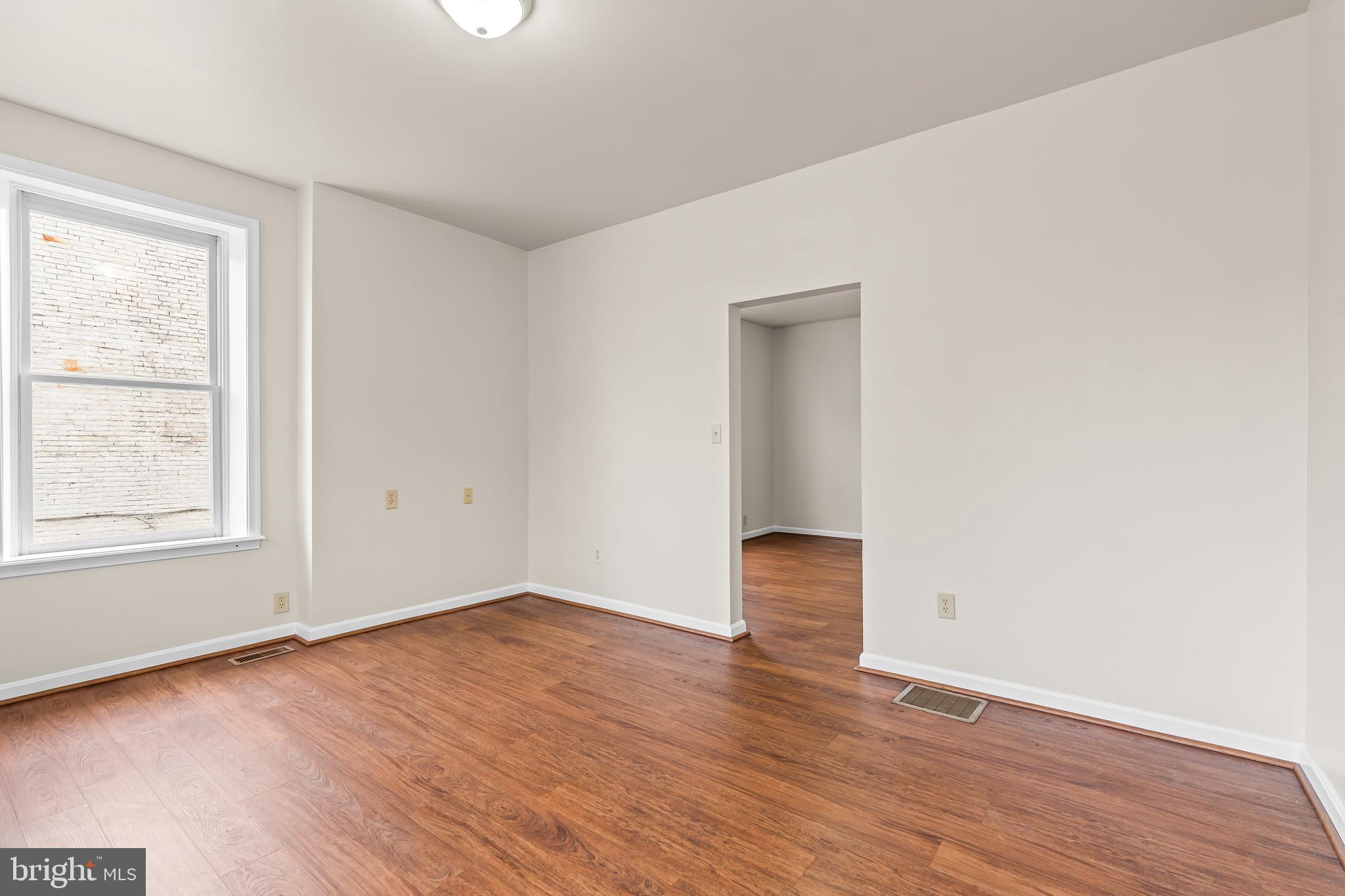 44 Madison Avenue Hagerstown, MD 21740 - Photo 7 of 24 an empty room with wooden floor and windows