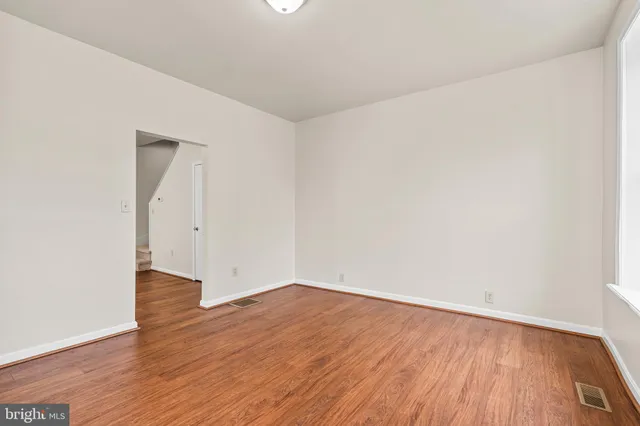 an empty room with wooden floor
