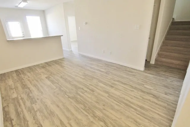 wooden floor in an empty room with a mirror