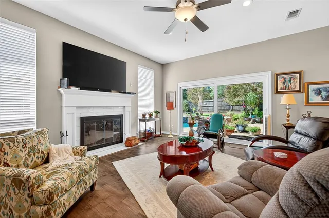 a living room with furniture fireplace and flat screen tv
