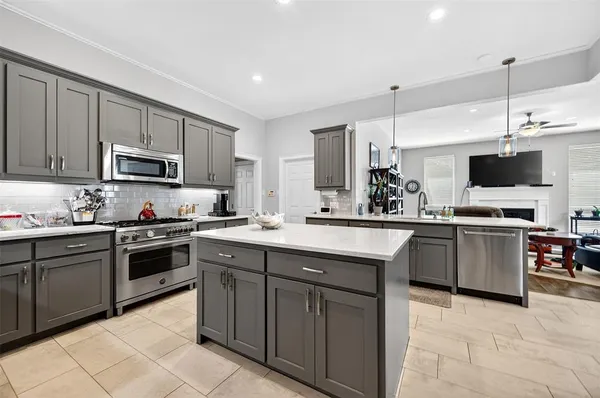 a kitchen with cabinets a microwave and stove