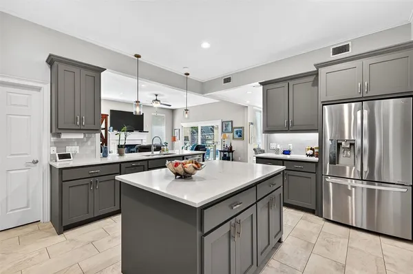 a kitchen with a sink a stove a refrigerator and cabinets