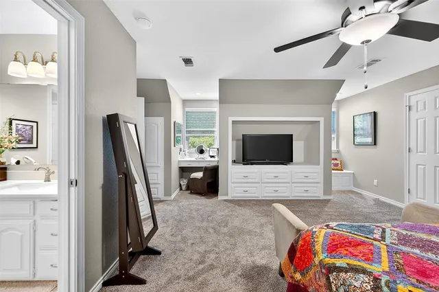a bedroom with furniture and a flat screen tv